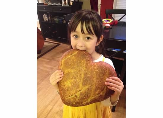 julia-Kid eating giant heart made of bread