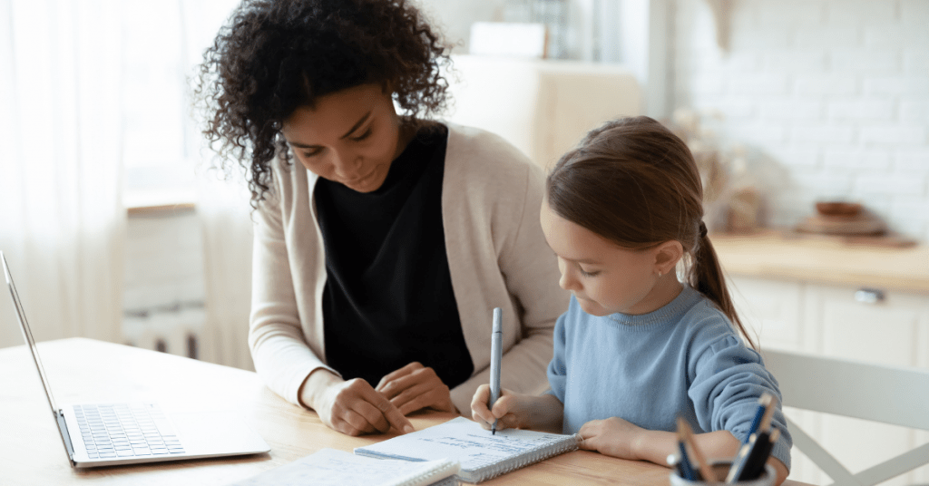 after school nanny helping child with homework