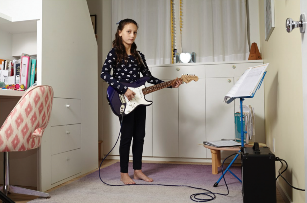 Mia rocks out in the bedroom her parents designed for her.