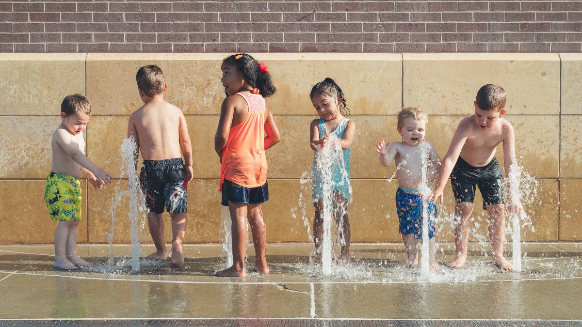 kids playing in fountain