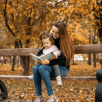 backup child care specialist reading outside on a bench