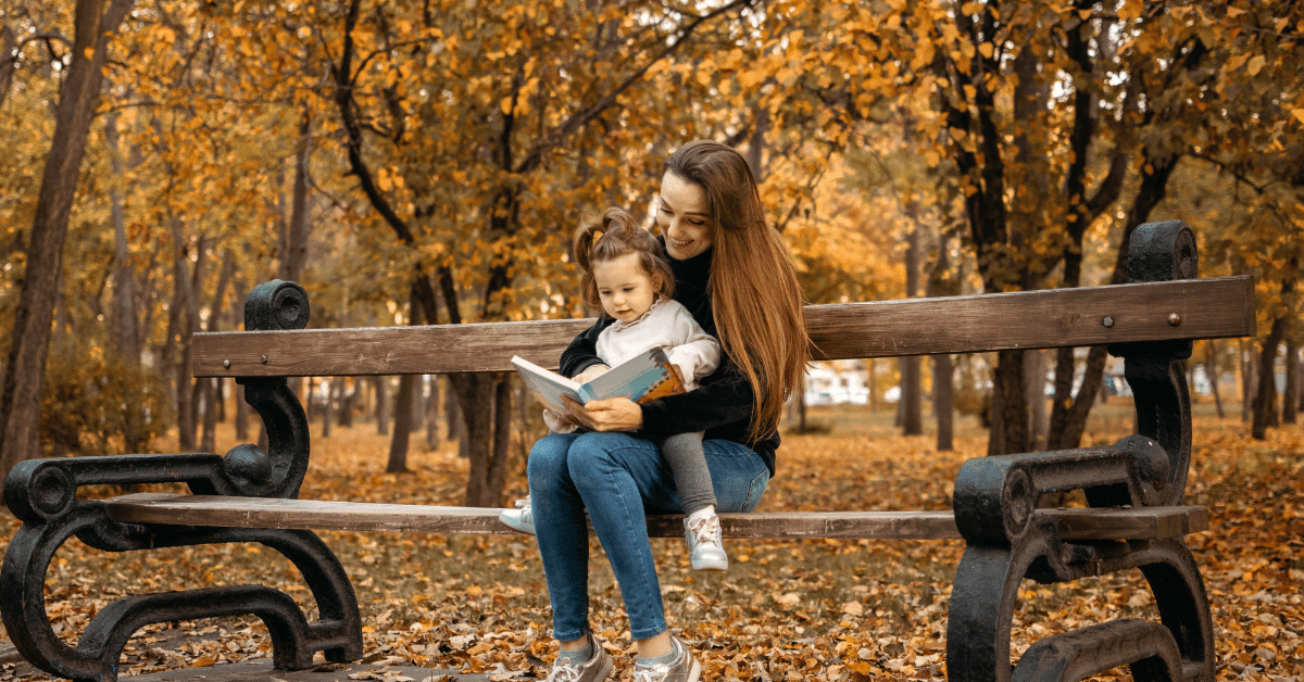 backup child care specialist reading outside on a bench