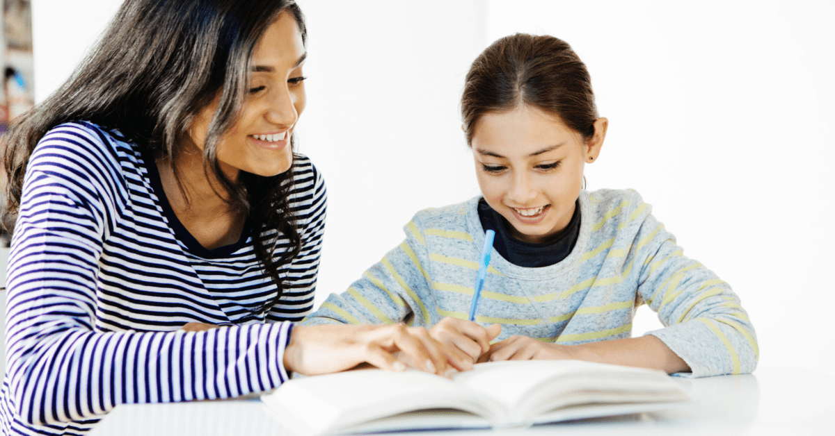 tutor assisting girl with assignment