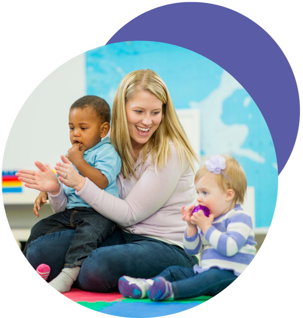 toddlers with a child care provider clapping and playing