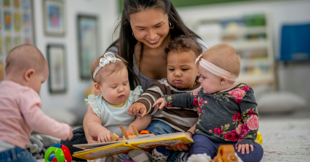 child care provider reading to toddlers and infants in a child day care