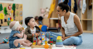 infant and toddler at daycare with teacher