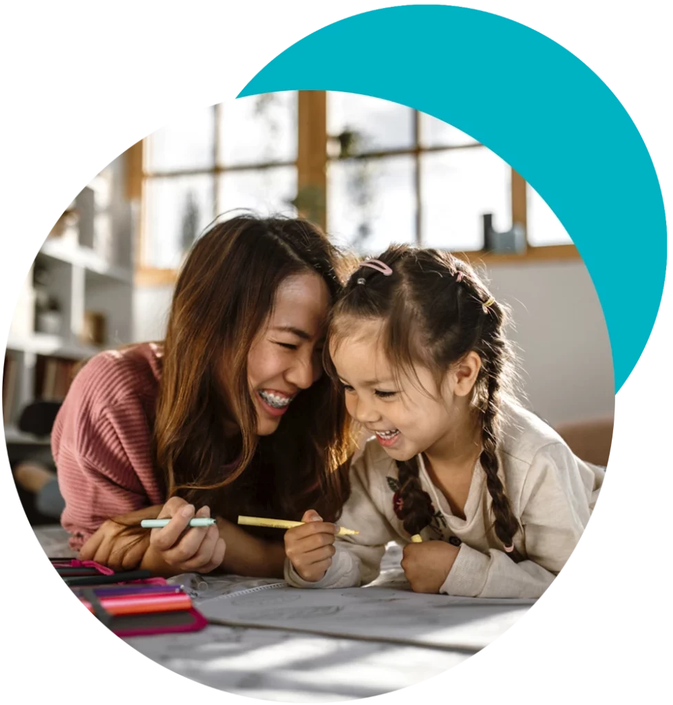 after school care nanny laughing with child on floor